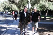 Lonny Powell walks with a student on the UA campus