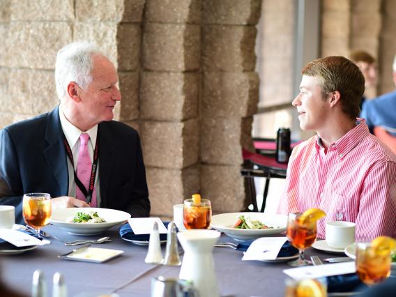 Frank Lamb has lunch with a student